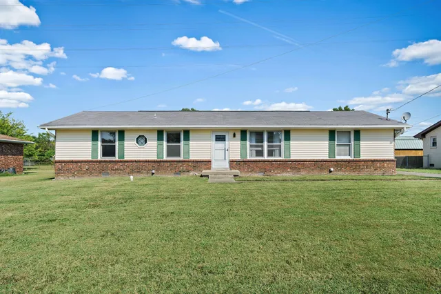 a front view of house with yard and green space