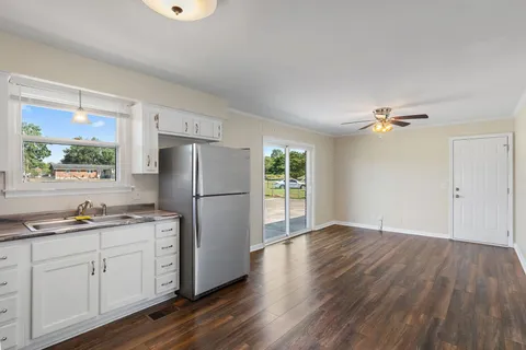 a kitchen with a refrigerator and windows