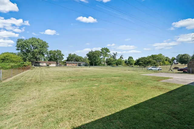 a view of outdoor space with garden and trees