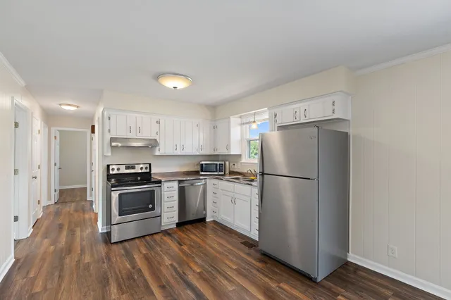 a kitchen with a refrigerator a stove top oven and kitchen island
