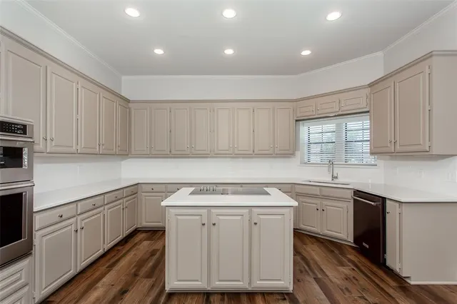 a utility room with cabinets washer and dryer