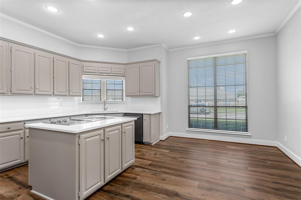2117 Promontory Point Plano, TX 75075 - Photo 14 of 37 a kitchen with a stove and a kitchen island