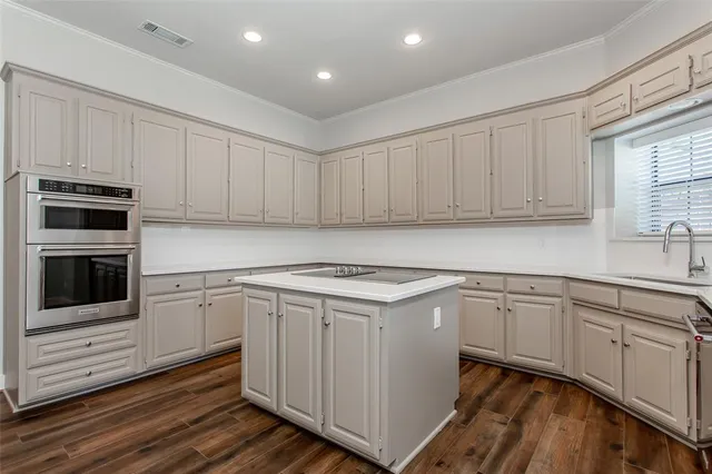 a kitchen with granite countertop white cabinets and white appliances
