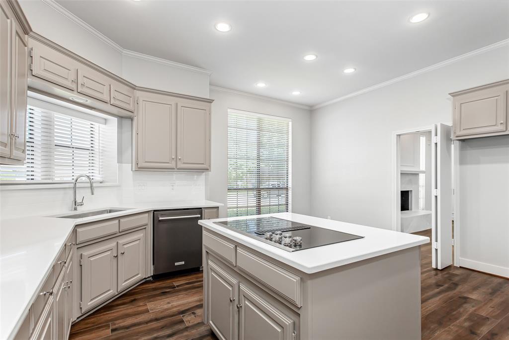 2117 Promontory Point Plano, TX 75075 - Photo 18 of 37 a kitchen that has a sink and a stove in it