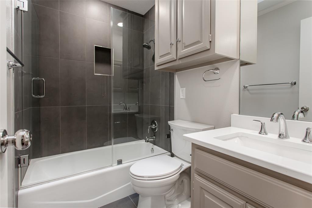 2117 Promontory Point Plano, TX 75075 - Photo 20 of 37 a bathroom with a sink a toilet and shower