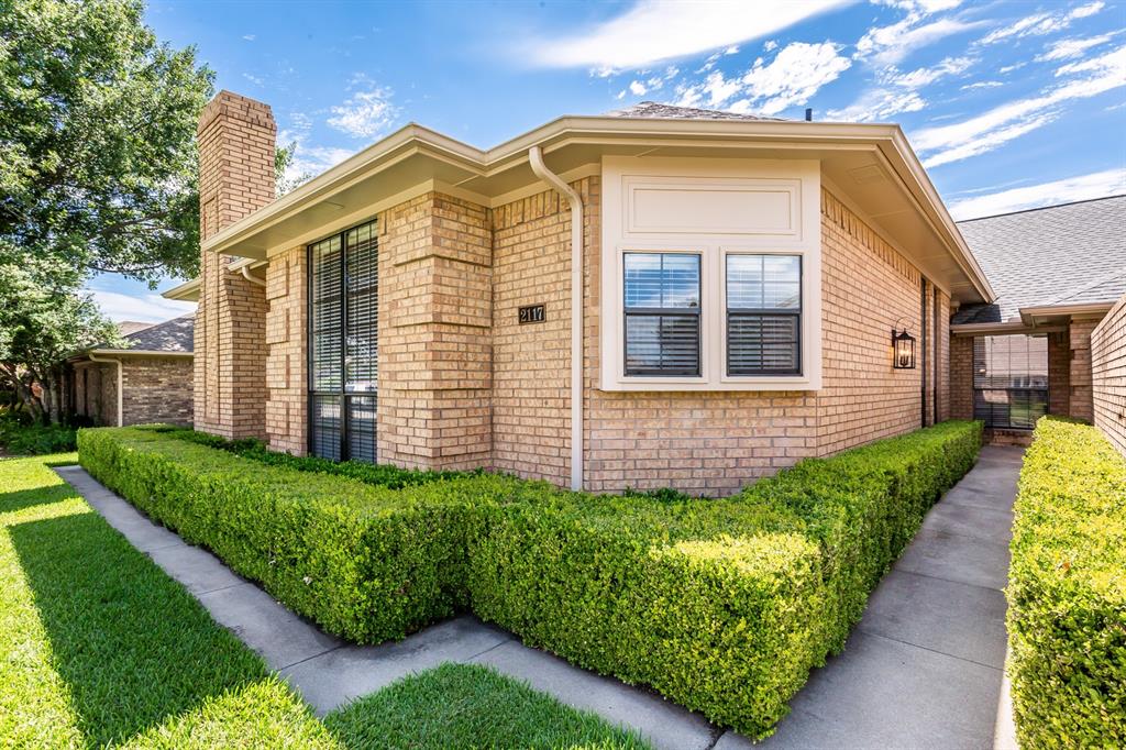 2117 Promontory Point Plano, TX 75075 - Photo 2 of 37 a front view of a house with a garden