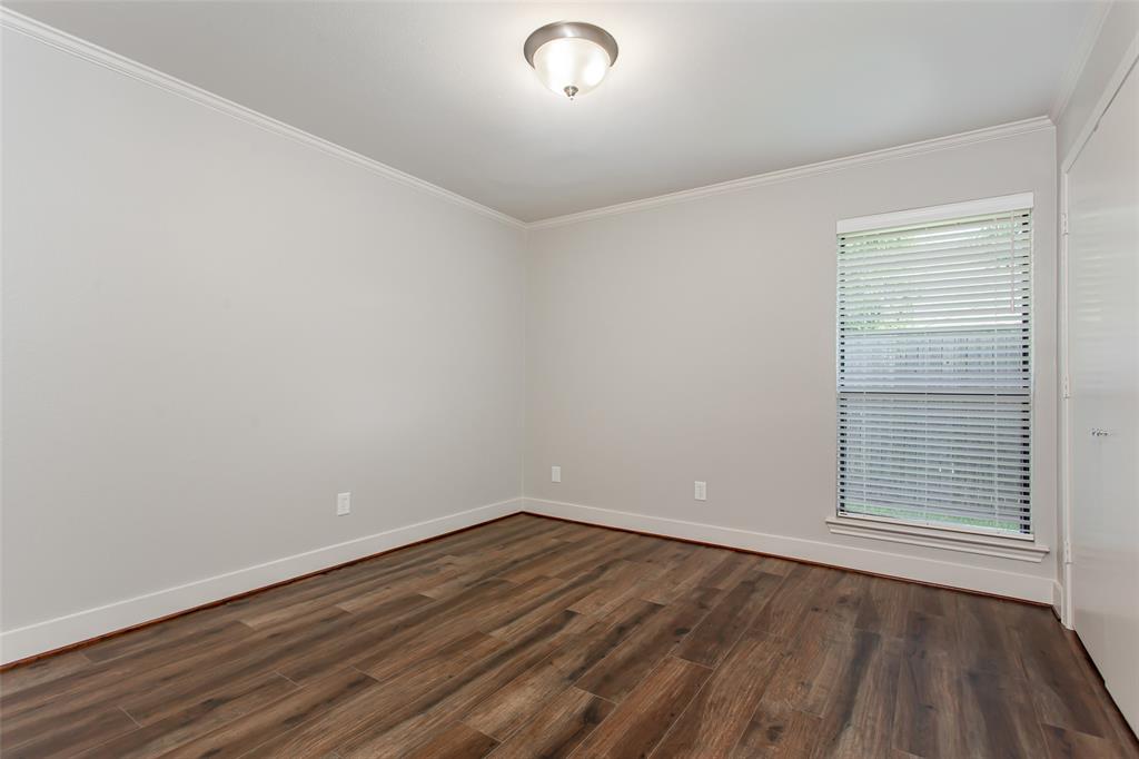 2117 Promontory Point Plano, TX 75075 - Photo 21 of 37 wooden floor in an empty room with a window