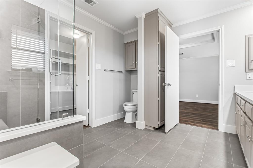 2117 Promontory Point Plano, TX 75075 - Photo 27 of 37 a bathroom with a sink and a large mirror