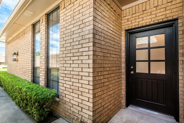 a view of a door and brick walls