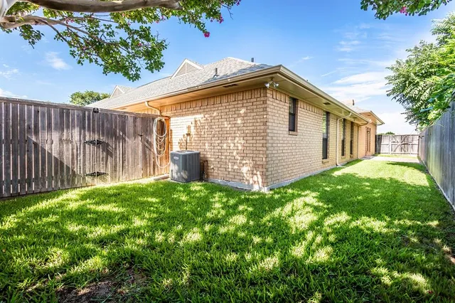 a view of backyard of house with green space