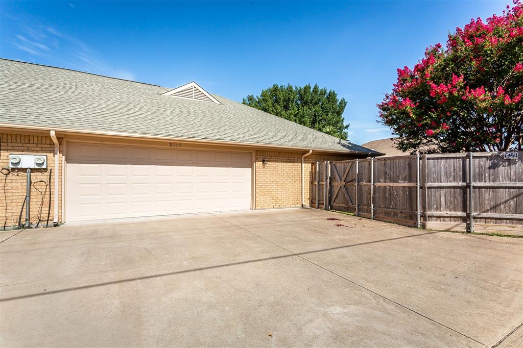 2117 Promontory Point Plano, TX 75075 - Photo 35 of 37 a view of backyard with small cabin and wooden fence