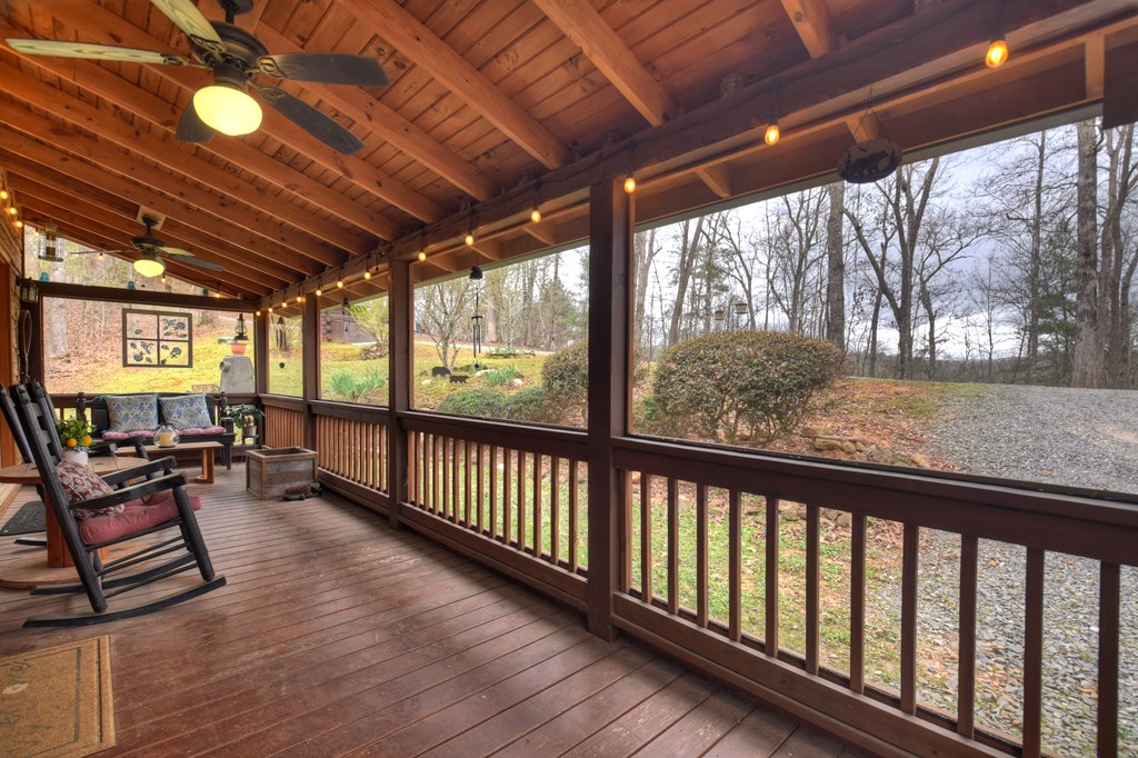 111 Roaring Creek Road Epworth, GA 30541 - Photo 17 of 63 a view of a porch with furniture and wooden floor