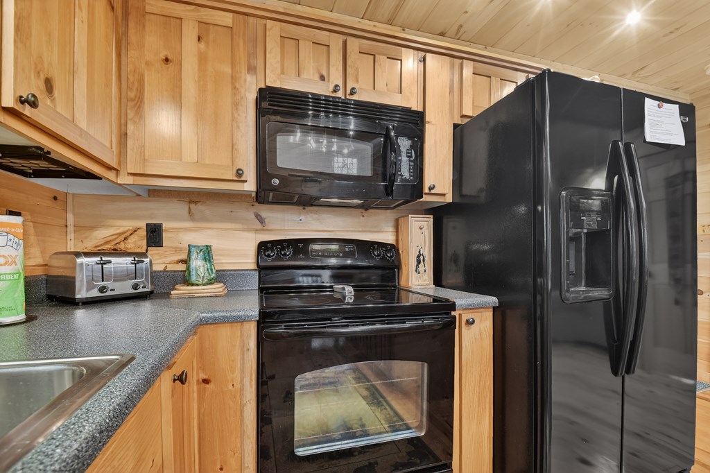 111 Roaring Creek Road Epworth, GA 30541 - Photo 19 of 63 a kitchen with stainless steel appliances granite countertop a stove microwave and refrigerator