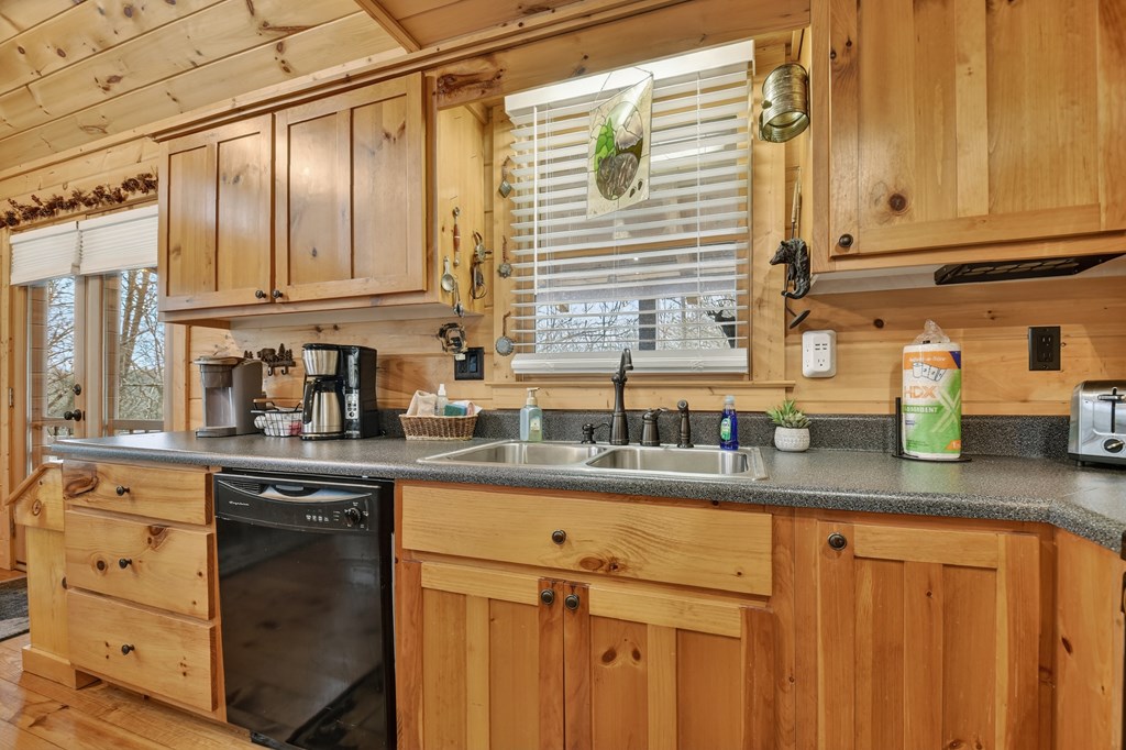 111 Roaring Creek Road Epworth, GA 30541 - Photo 26 of 63 a kitchen with stainless steel appliances granite countertop a sink and cabinets