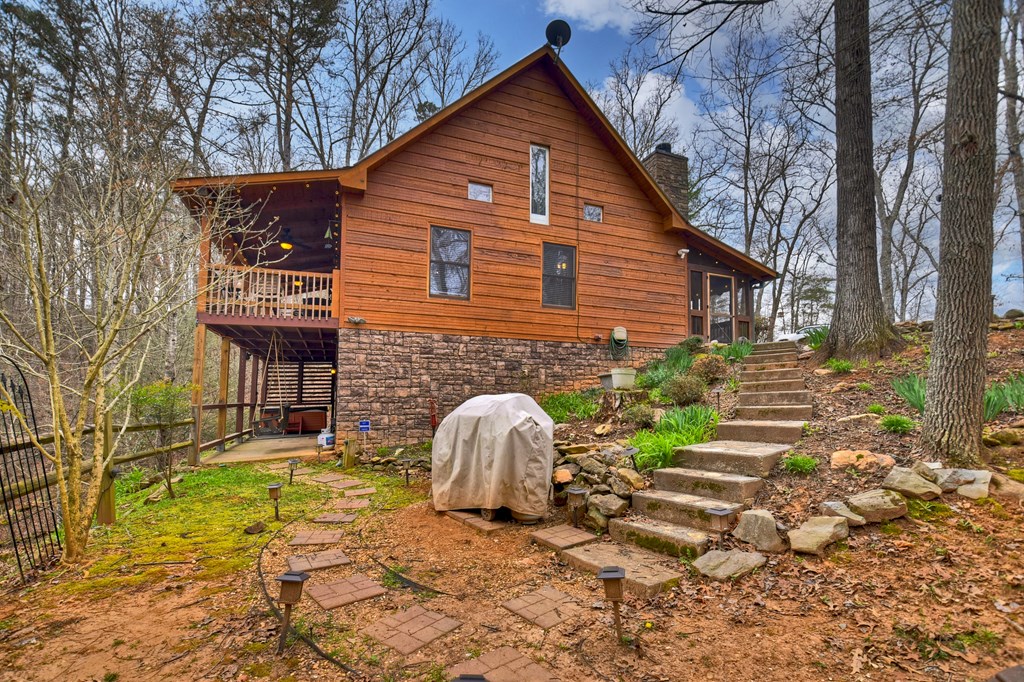 111 Roaring Creek Road Epworth, GA 30541 - Photo 39 of 63 a backyard of a house with table and chairs