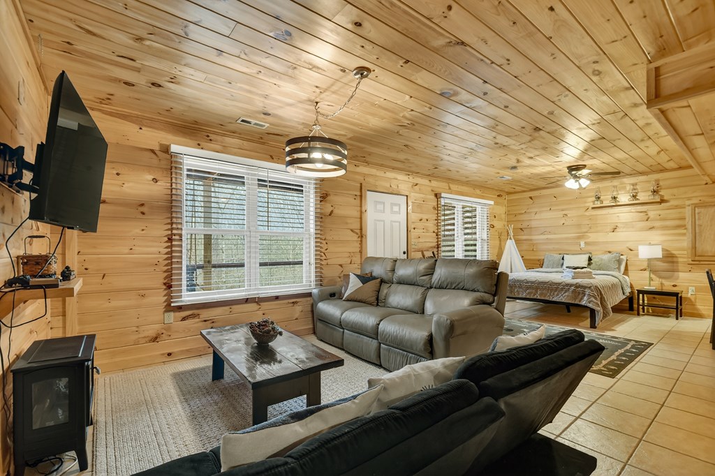 111 Roaring Creek Road Epworth, GA 30541 - Photo 43 of 63 a living room with furniture and a flat screen tv