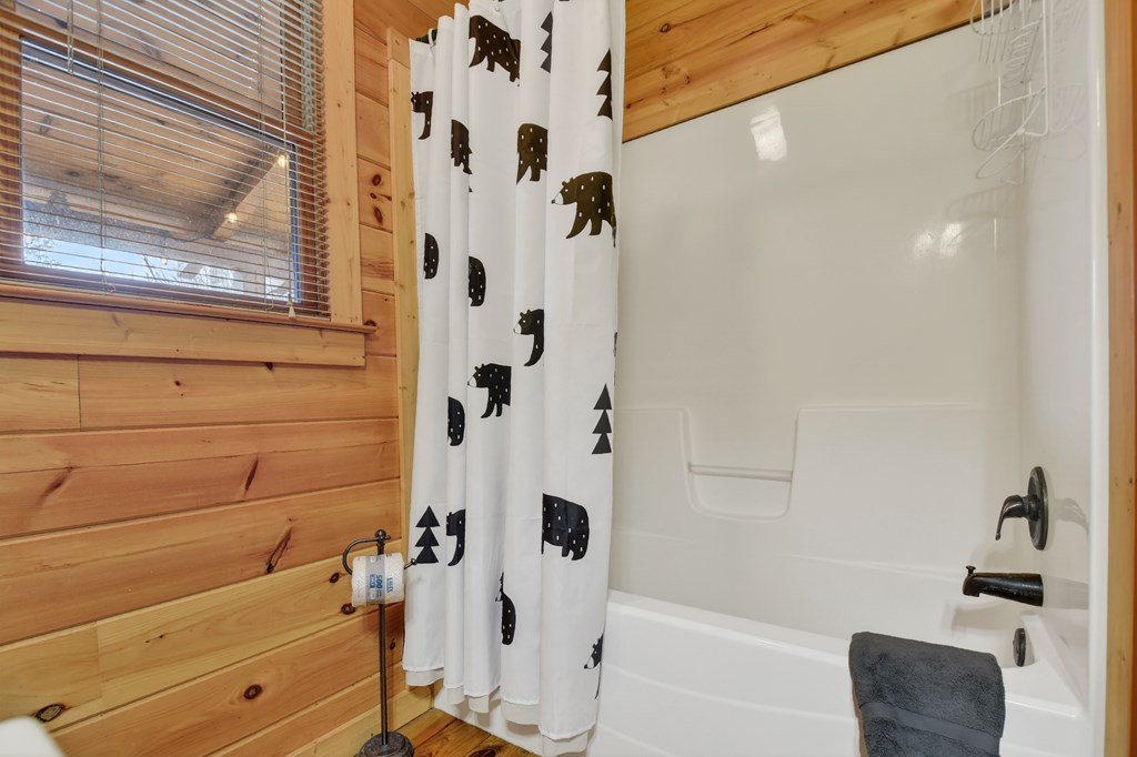 111 Roaring Creek Road Epworth, GA 30541 - Photo 55 of 63 a bathroom with a bathtub and a shower