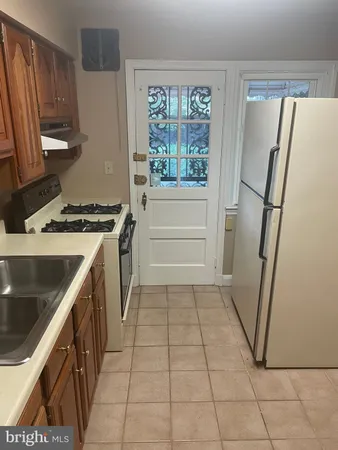 a kitchen with a sink a refrigerator and a stove
