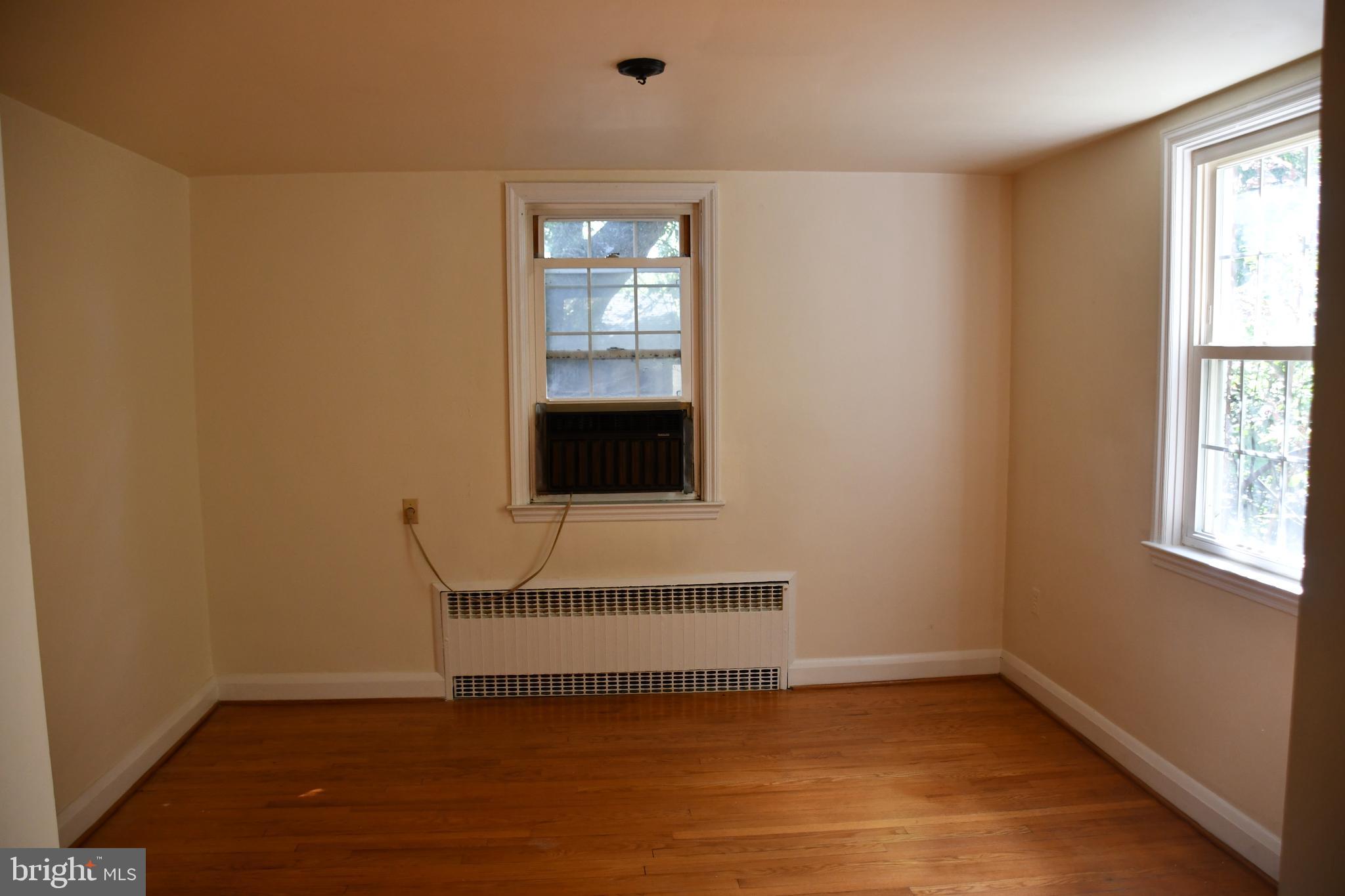 615 Overbrook Road Baltimore, MD 21212 - Photo 12 of 48 a view of an empty room with wooden floor and a window