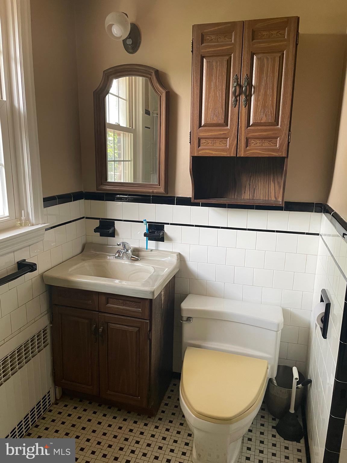 615 Overbrook Road Baltimore, MD 21212 - Photo 13 of 48 a bathroom with a granite countertop toilet sink and mirror