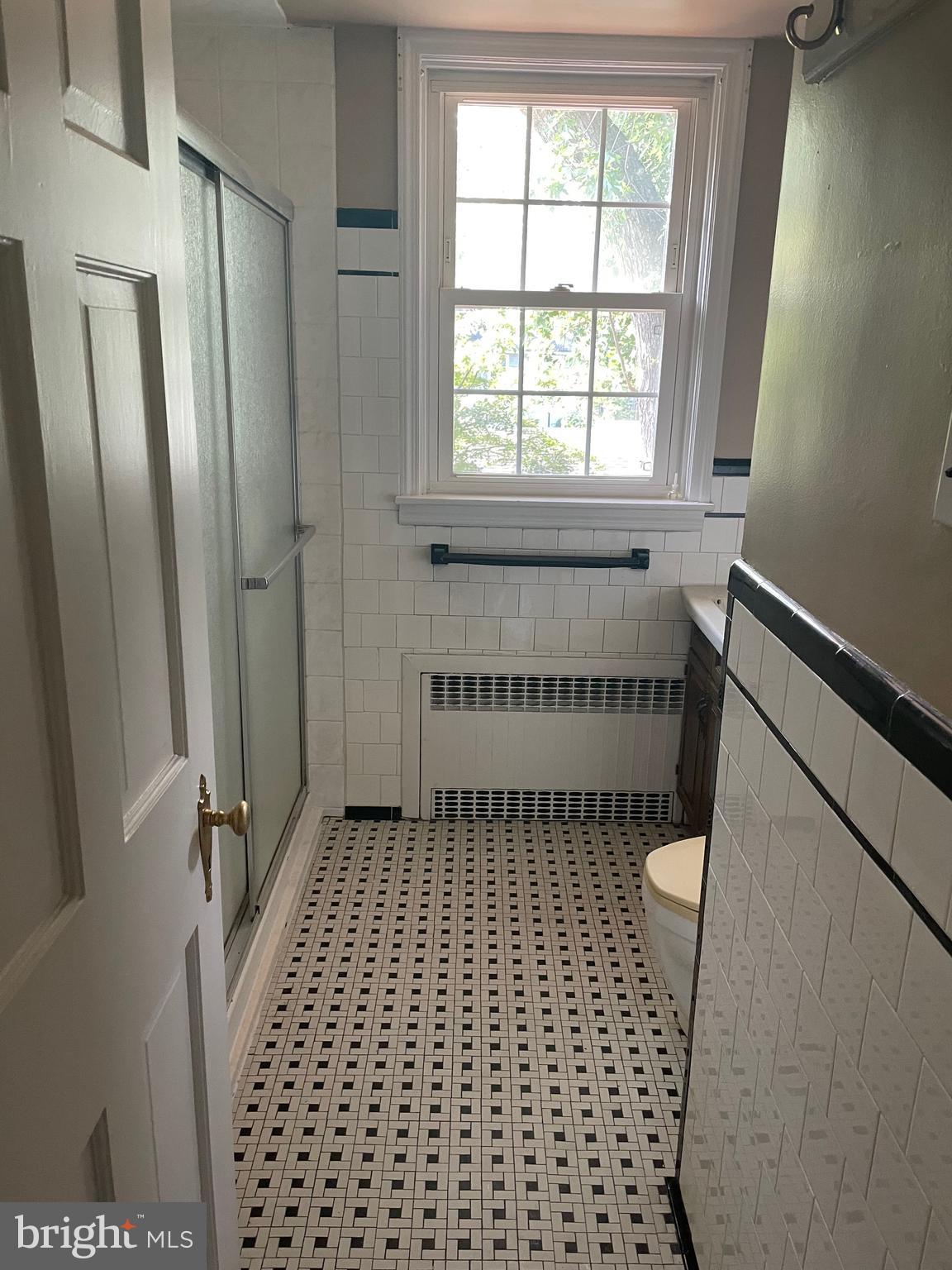 615 Overbrook Road Baltimore, MD 21212 - Photo 15 of 48 a bathroom with a sink a toilet a window