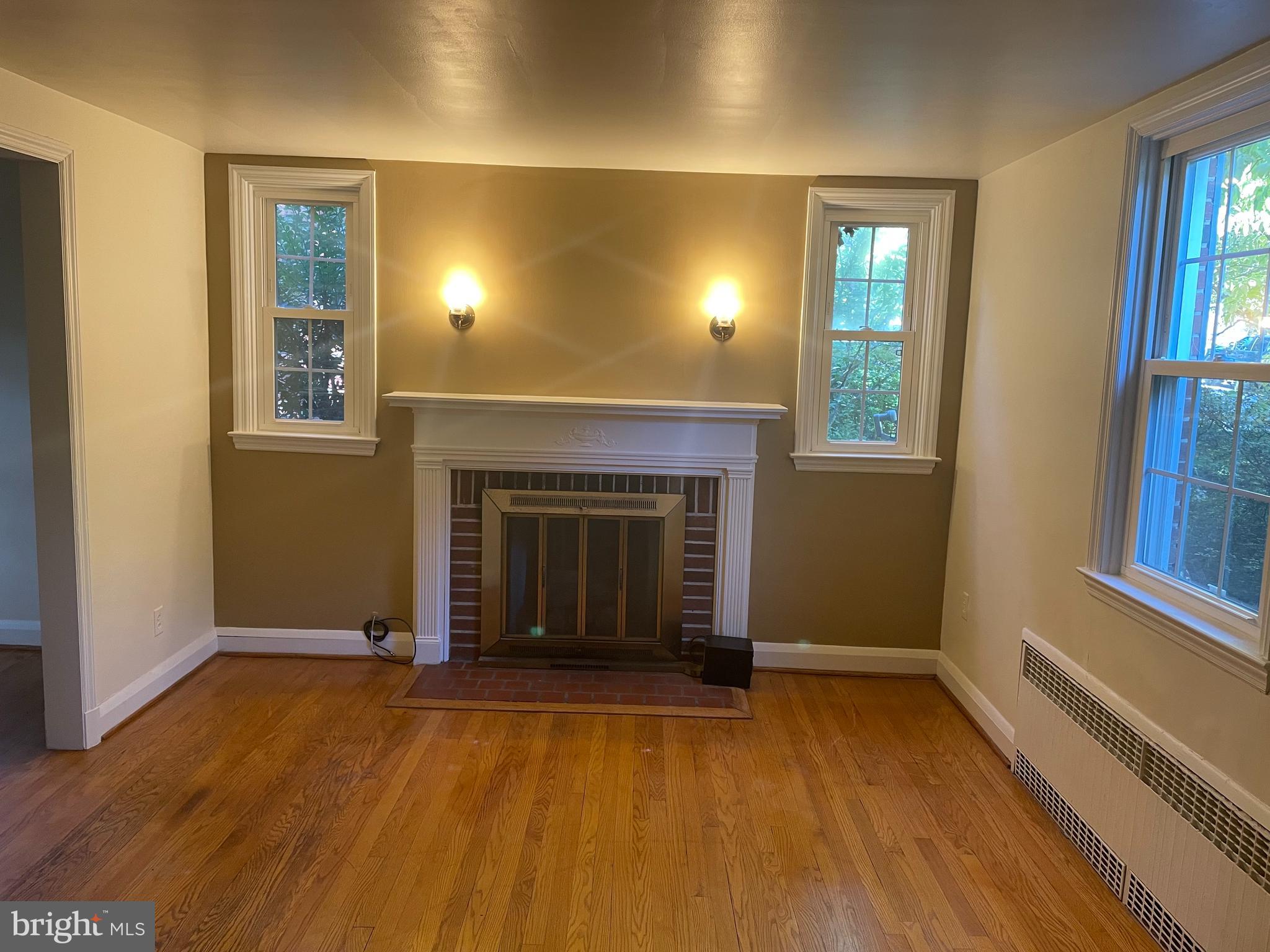 615 Overbrook Road Baltimore, MD 21212 - Photo 2 of 48 an empty room with windows and fireplace