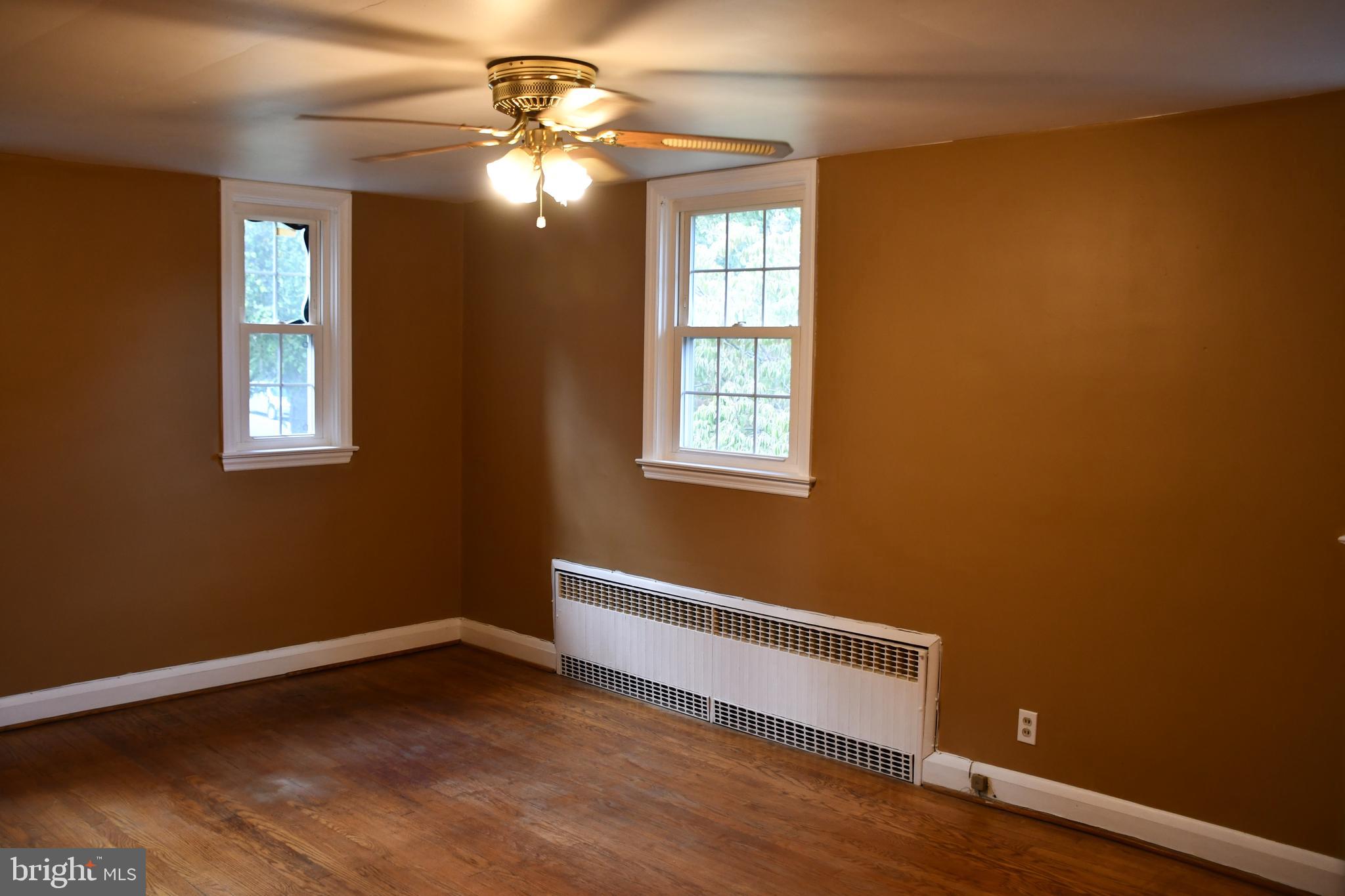 615 Overbrook Road Baltimore, MD 21212 - Photo 21 of 48 a view of an empty room with a window and wooden floor