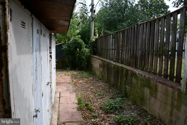 a view of a pathway of a wooden fence