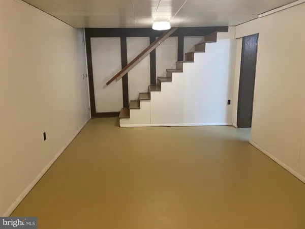 a view of an empty room with stairs