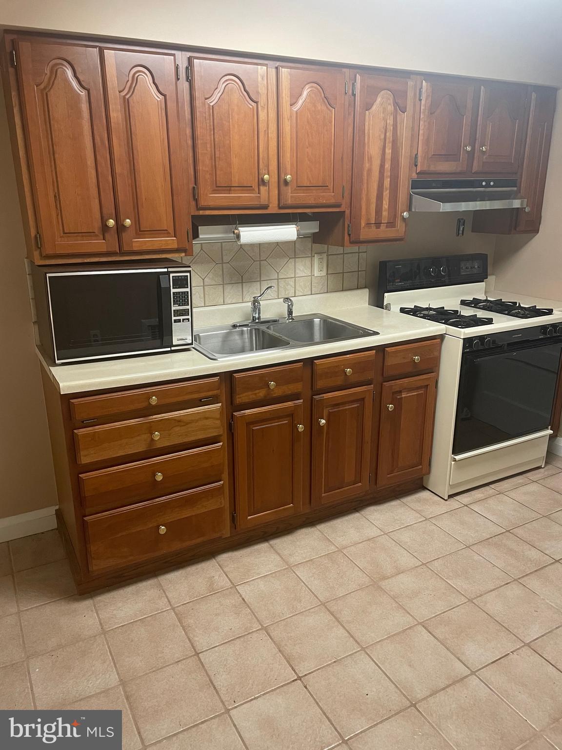 615 Overbrook Road Baltimore, MD 21212 - Photo 10 of 48 a kitchen with stainless steel appliances granite countertop a stove a sink and a microwave