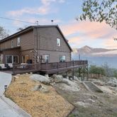 a view of house with yard and sitting area