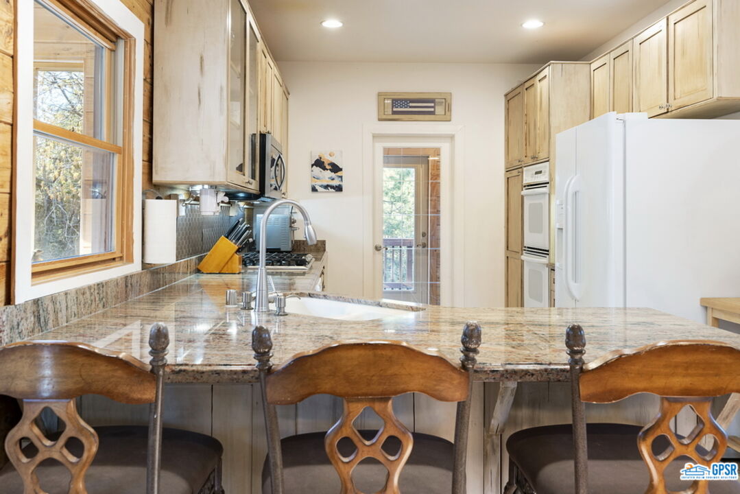 53305 Big Rock Drive Idyllwild, CA 92549 - Photo 22 of 67 a bathroom with a granite countertop sink and a large mirror