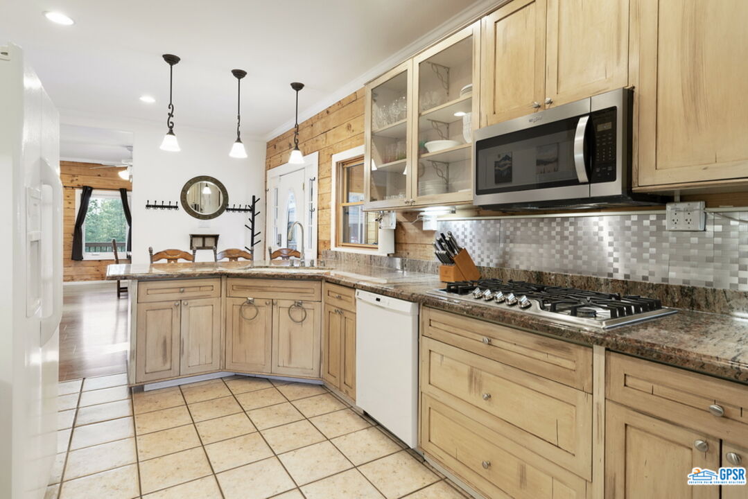 53305 Big Rock Drive Idyllwild, CA 92549 - Photo 23 of 67 a kitchen with stainless steel appliances granite countertop a sink a stove and cabinets