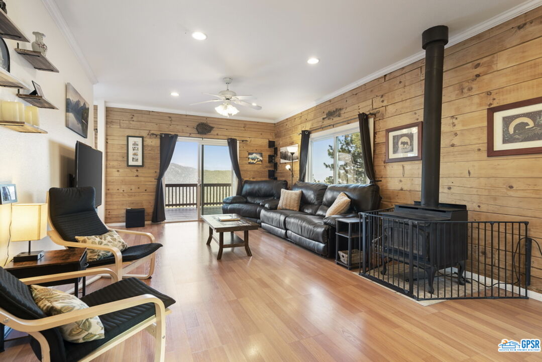 53305 Big Rock Drive Idyllwild, CA 92549 - Photo 26 of 67 a living room with furniture a wooden floor and a fireplace