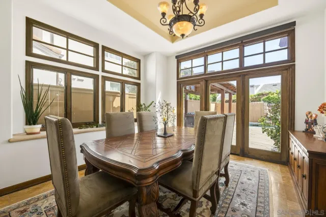 a view of a dining room with furniture large windows and wooden floor