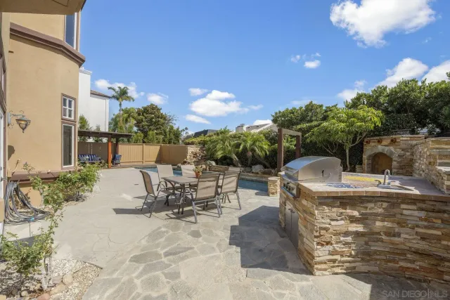 a view of a patio with table and chairs and potted plants