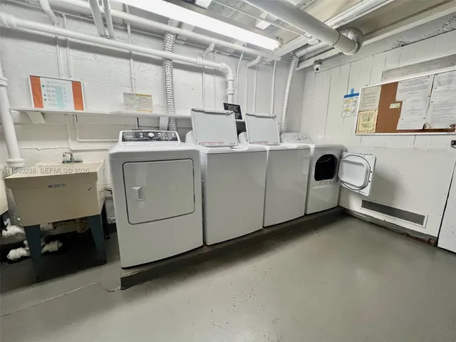 a utility room with multiple dryer and washer