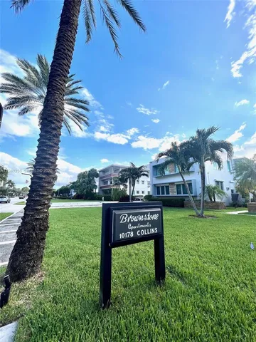 a view of a park with a big yard and potted plants