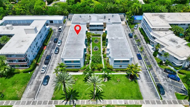 an aerial view of multiple houses with yard