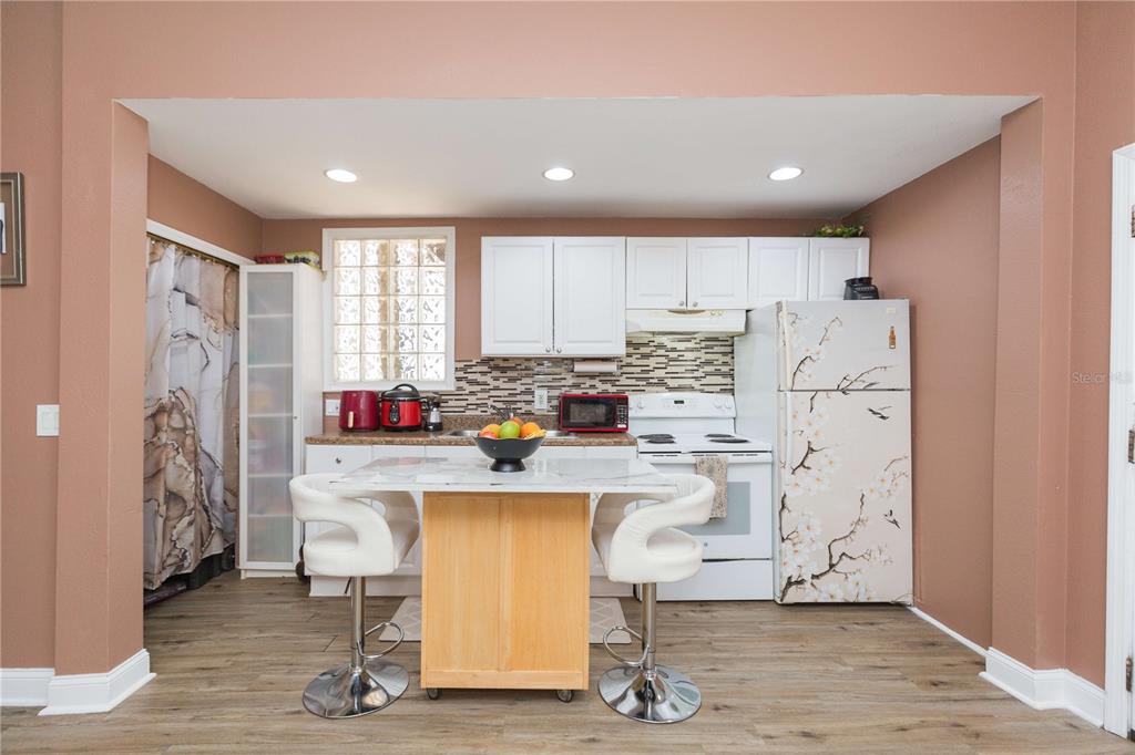 2322 West Cherry Street Tampa, FL 33607 - Photo 5 of 36 a kitchen with refrigerator and cabinets