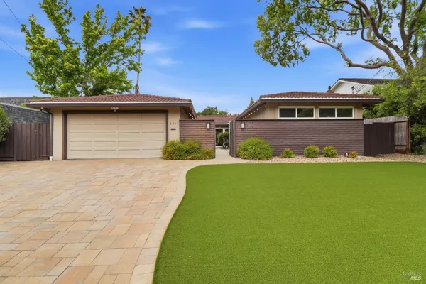 a front view of a house with a garden