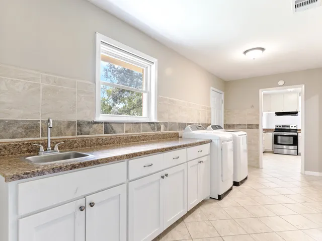 a kitchen with a sink cabinets and window