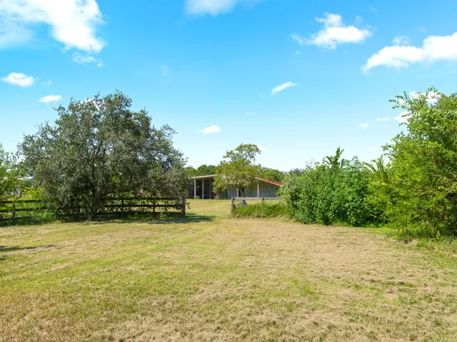 a view of a swimming pool and a yard
