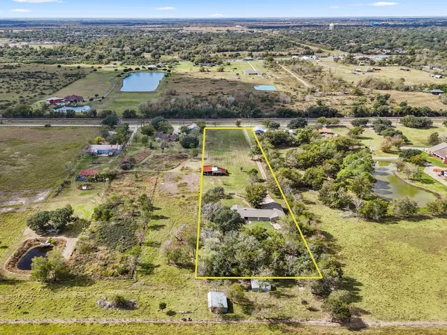 an aerial view of residential houses with outdoor space