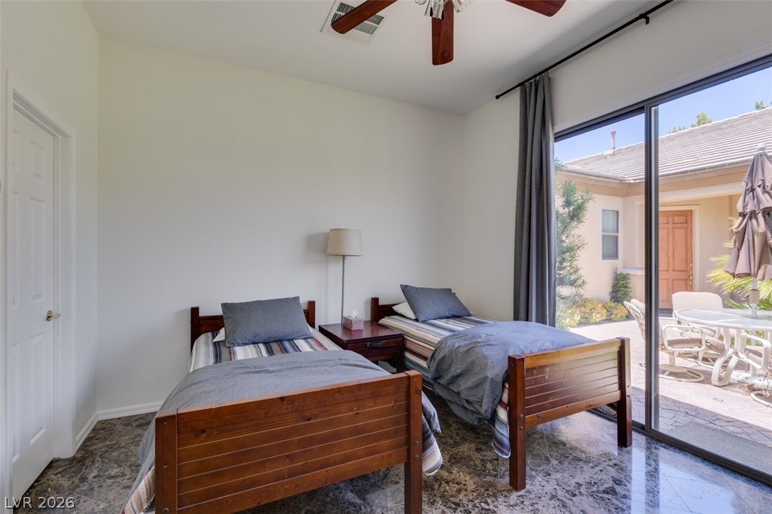 8 Kennesaw Road Henderson, NV 89052 - Photo 36 of 44 Floor-to-ceiling glass sliders illuminate this bedroom, offering a delightful patio view.