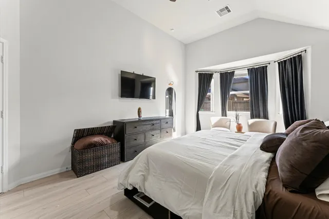 a bedroom with a bed and a television