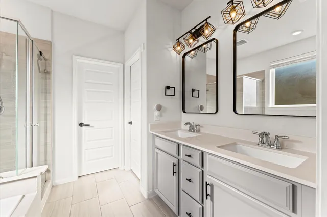 a bathroom with a double vanity sink mirror and
