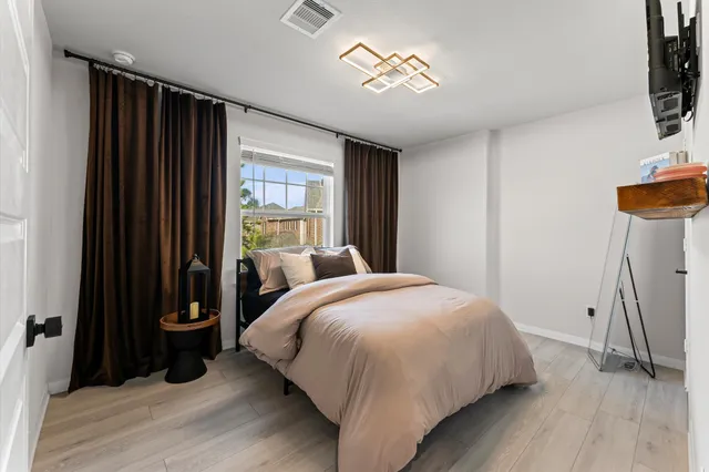 a bedroom with a bed and a window