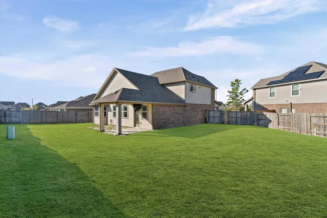 a view of a house with a yard and a garden