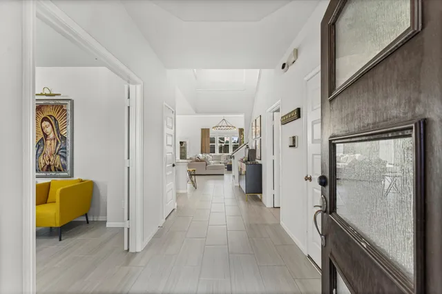a view of a hallway with wooden floor and furniture